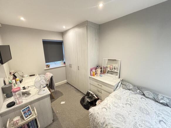 A cozy and well-maintained bedroom featuring a ...