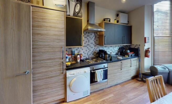 A bright and modern kitchen featuring ample wor...