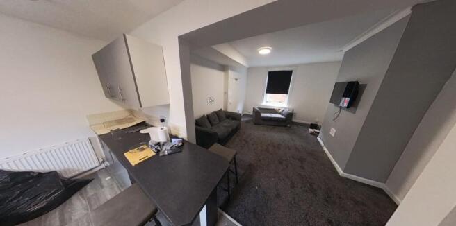 A spacious and well-lit living room with contem...