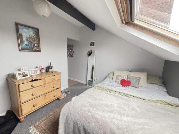 A bright and inviting master bedroom featuring ...