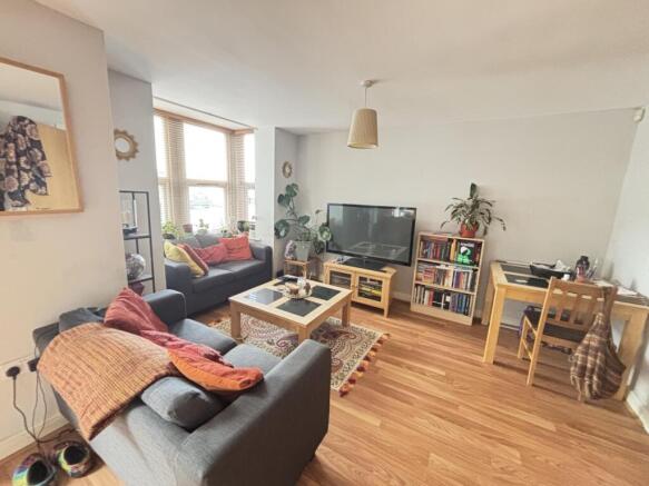 A bright, spacious living room with comfortable...