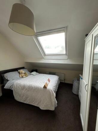 A cozy and well-maintained bedroom with a comfo...