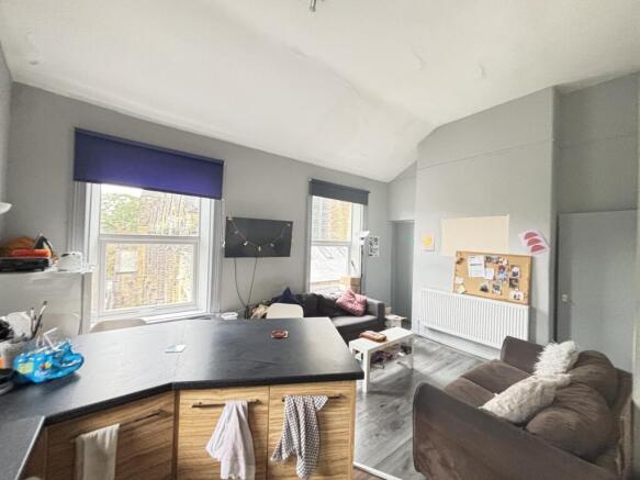 A well-lit and modern living room featuring lar...