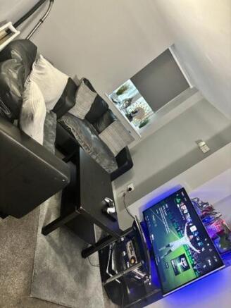 A modern living room featuring a large flat-scr...