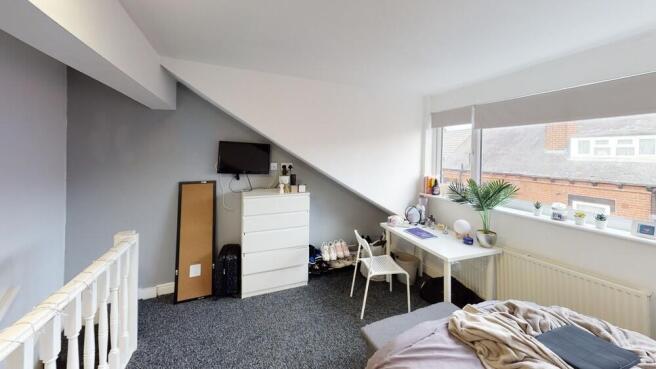 Bright and welcoming living room with ample nat...