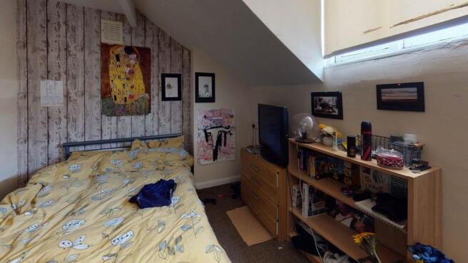 A cozy bedroom featuring a comfortable double b...