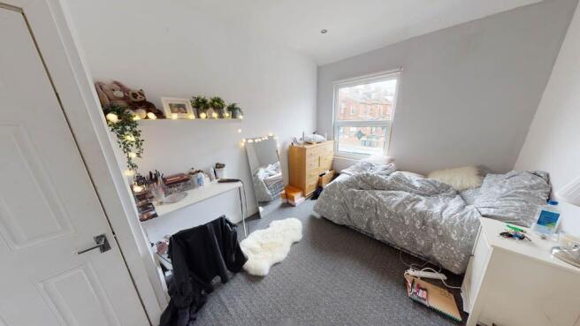 Bright and spacious double bedroom featuring a ...