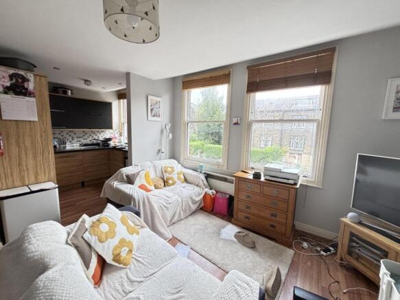 A bright and inviting living room featuring lar...