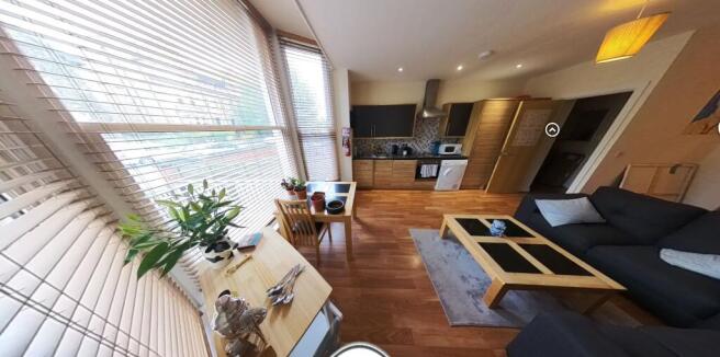 A bright and modern living room featuring large...