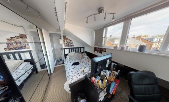 Bright and spacious living room with large wind...