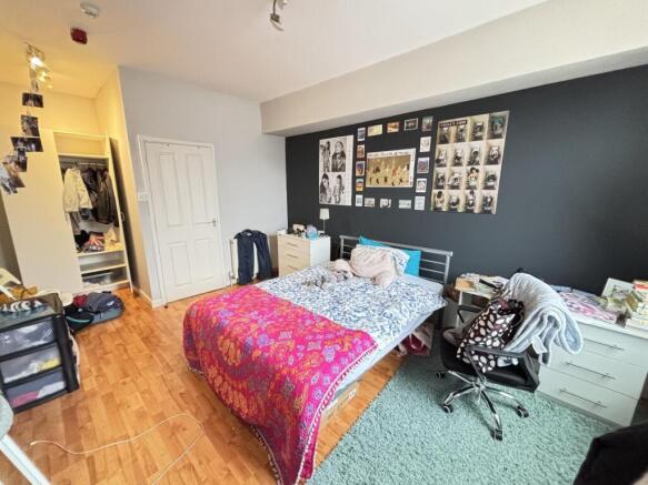 Bright and spacious master bedroom with a large...