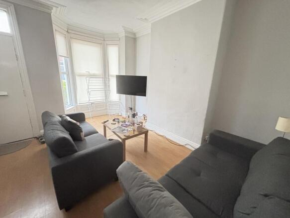 A bright and welcoming living room featuring tw...