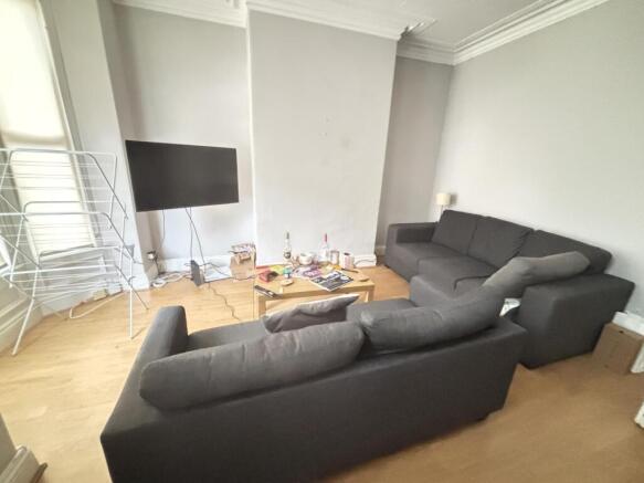 A spacious and well-lit contemporary living roo...