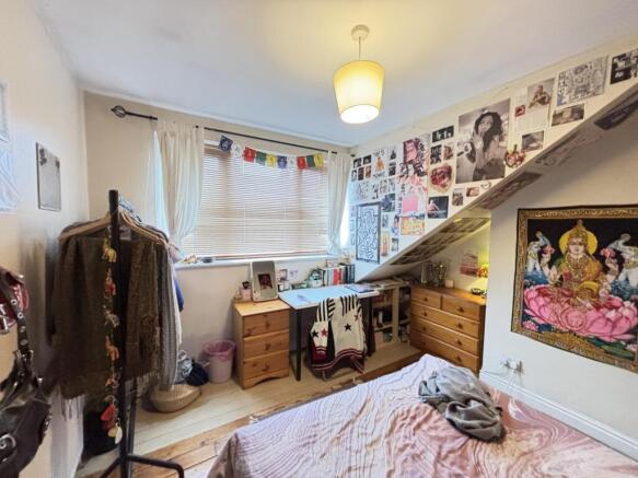 A spacious and well-lit master bedroom featurin...