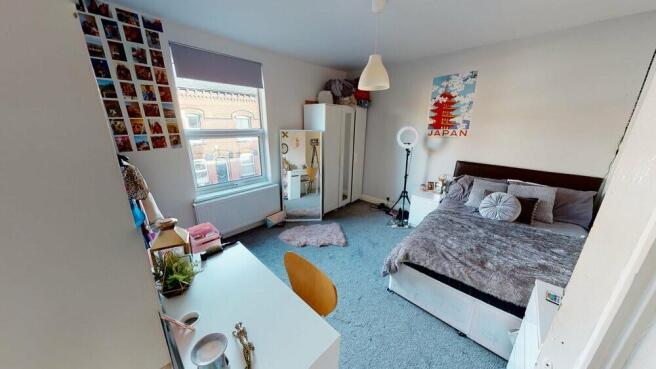 A bright and cozy double bedroom featuring a la...