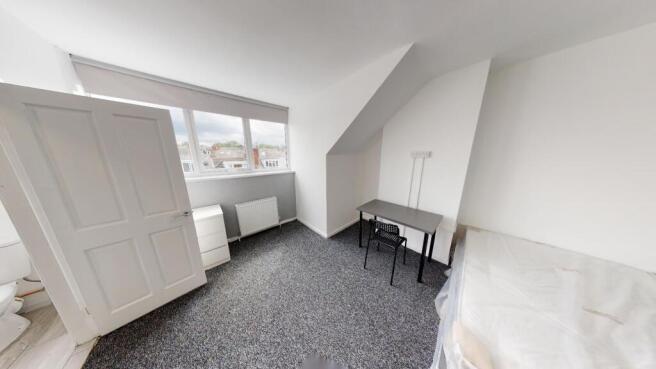 Spacious and bright master bedroom with ample n...