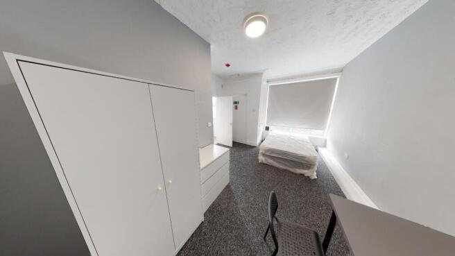 A bright, well-maintained bedroom with a clean ...