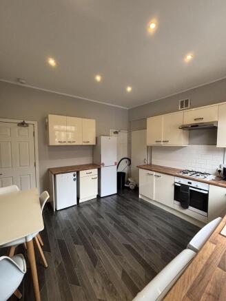 A modern, well-maintained kitchen featuring sle...