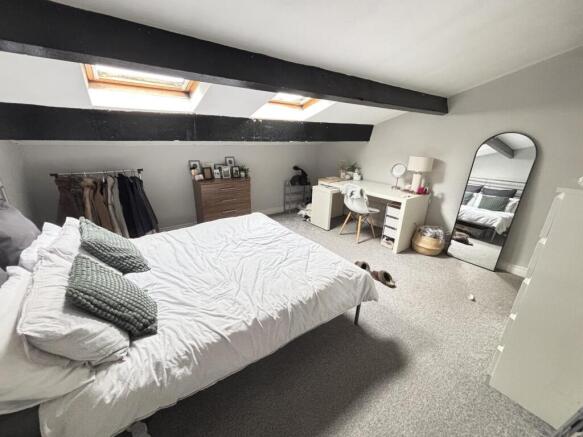 Bright and airy master bedroom with large windo...