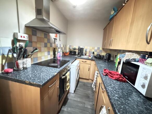 A well-equipped kitchen featuring wooden cabine...