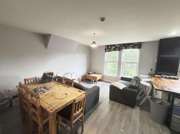 A bright and welcoming living room featuring a ...