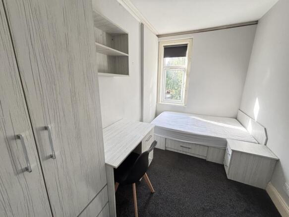 A well-maintained single bedroom featuring a be...