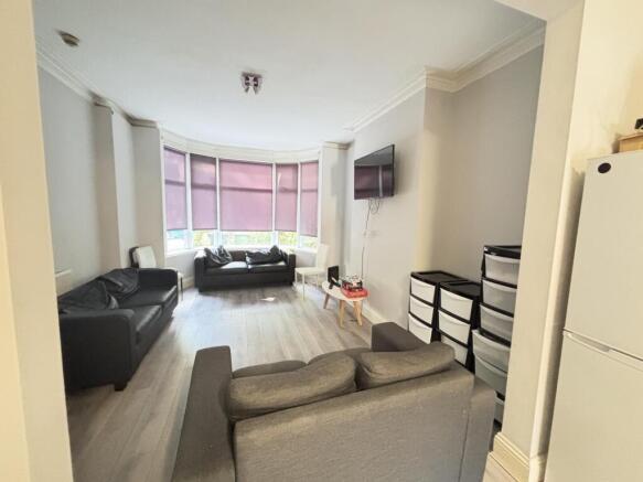 A spacious and well-lit living room with comfor...