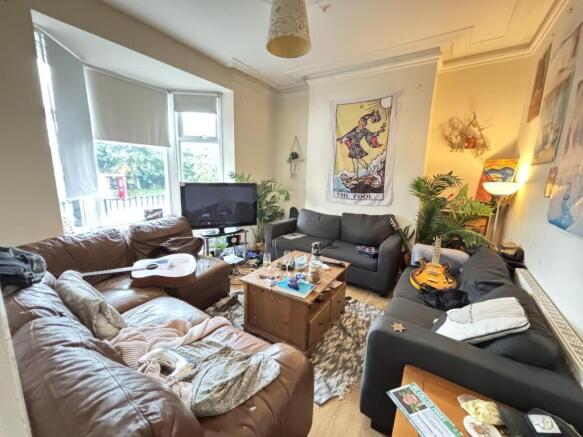 A spacious and welcoming living room filled wit...