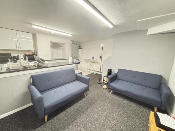 A spacious and modern living room featuring two...