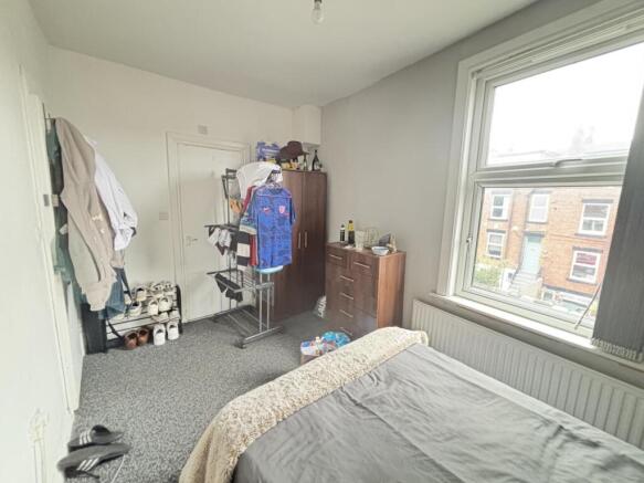 Bright and inviting bedroom with a large window...