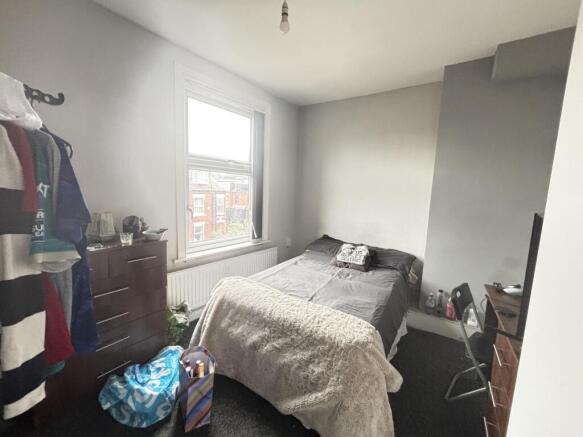 Spacious and well-lit master bedroom featuring ...