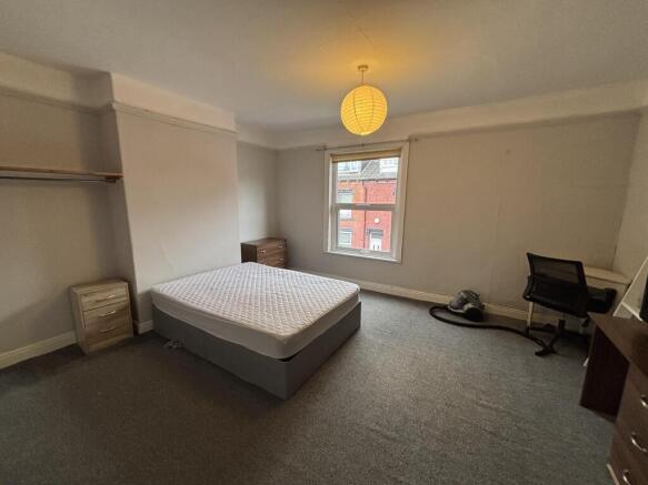 Spacious and well-lit master bedroom featuring ...