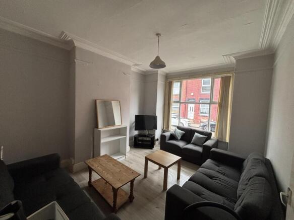 A bright and inviting living room featuring com...