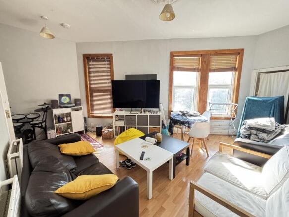 A bright and welcoming living room featuring la...
