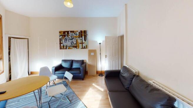 A bright and welcoming living room featuring co...