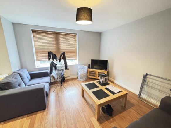 A cozy living room featuring a comfortable dark...
