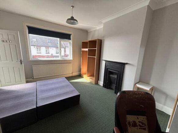 A bright and welcoming living room with a large...