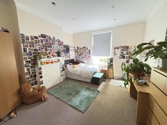 A bright and spacious master bedroom featuring ...