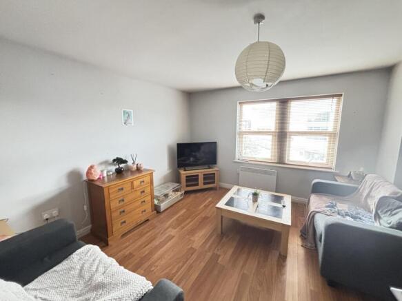 A bright and inviting living room featuring lar...