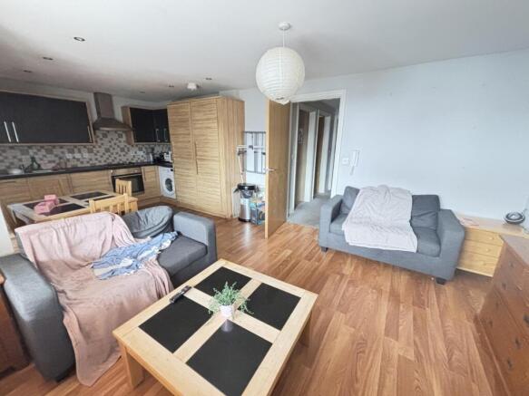 A spacious, well-lit living room featuring mode...