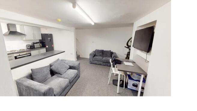 A modern and well-lit living room featuring com...