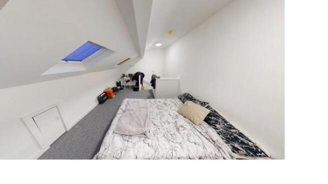 Bright and airy master bedroom with a comfortab...