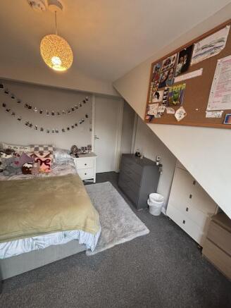 A cozy and inviting bedroom featuring a neatly ...