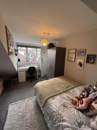 A cozy and inviting double bedroom featuring a ...