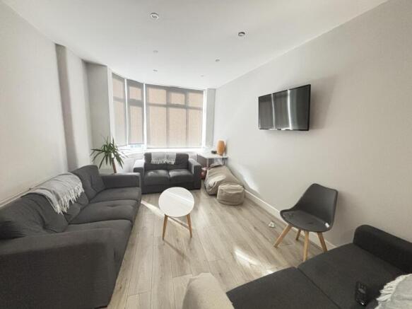Bright and modern living room featuring ample n...