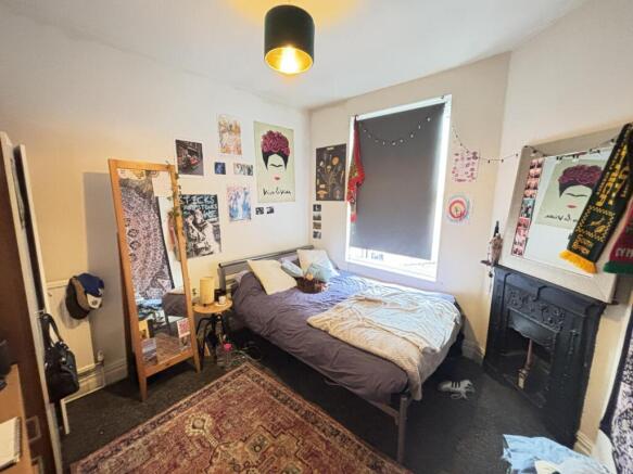 A spacious and cozy master bedroom featuring a ...