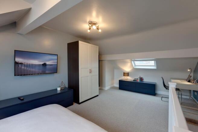 Bright and spacious master bedroom featuring a ...