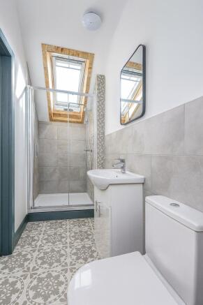 Bright and modern bathroom featuring a skylight...