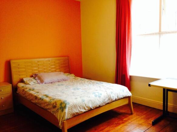 Bright and welcoming master bedroom featuring w...