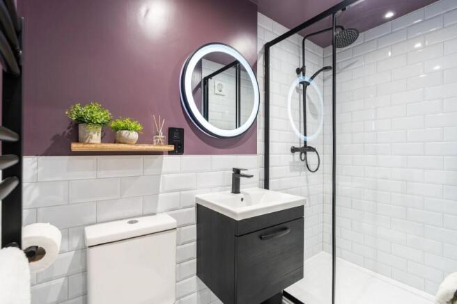 Modern bathroom featuring white subway tiles, a...